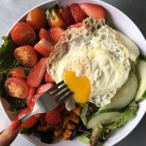 Gluten-free salad with an egg and berries from The Granola Bar